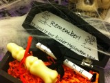 a black coffin filled with candies and sweets and with information is a cool party invitation