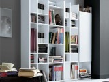 a minimalist library nook organized with a white bookcase with closed and open storage compartments in the living room