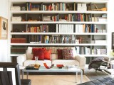 long open shelves that take a whole wall is a great idea to store a lot of books and such an item doubles as a home decor piece, too