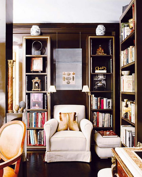 built-in bookshelves match the elegance of the room, and a white chair contrasts it and makes the space look bolder