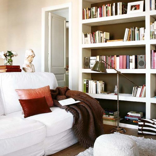 a built-in white bookcase with black inside is a cool and stylish idea for a contemporary space