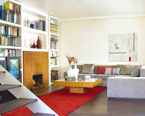 a refined living room with built-in bookshelves over the fireplace make the space very cozy and welcoming