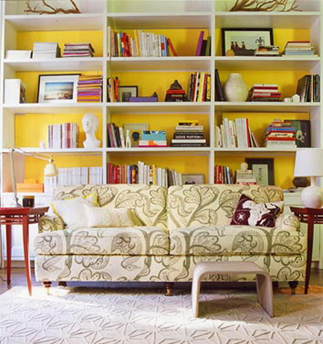 a bookcase with a sunny yellow backing is a nice and bold idea to go for, add a touch of color to your room