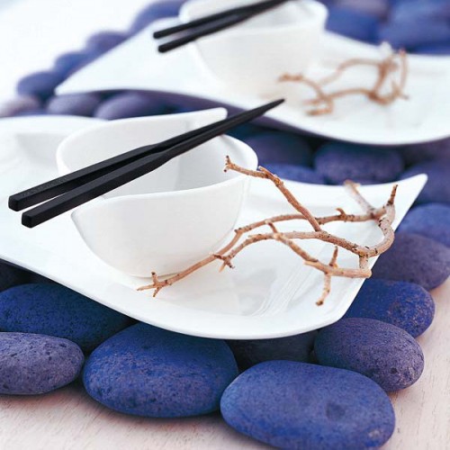 placemats made of large pebbles spray painted purple will add a bold colorful touch to the table setting