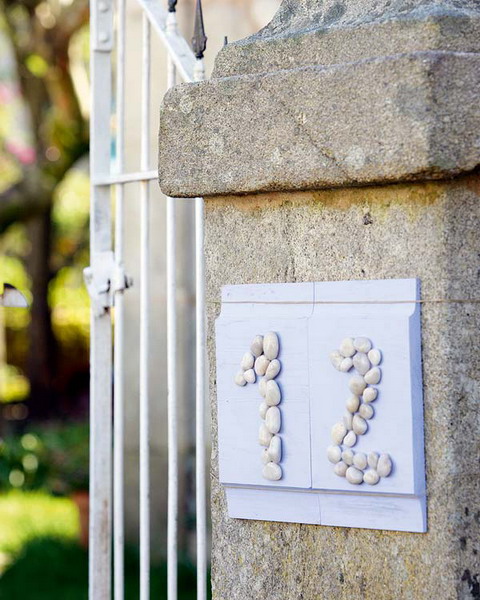a house number done with pebbles is a cute DIY for a coastal home