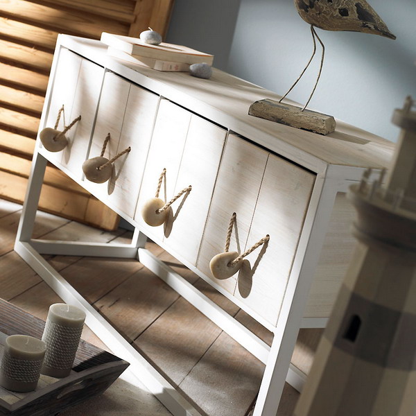 spruce up a usual sideboard adding rope and pebbles to the drawers as handles, it's a great idea for coastal houses