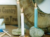large pebbles with holes drilled inside as simple and natural candle holders and candles inserted