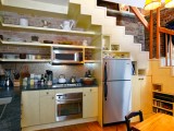 Kitchen With Open Shelves Under The Staircase