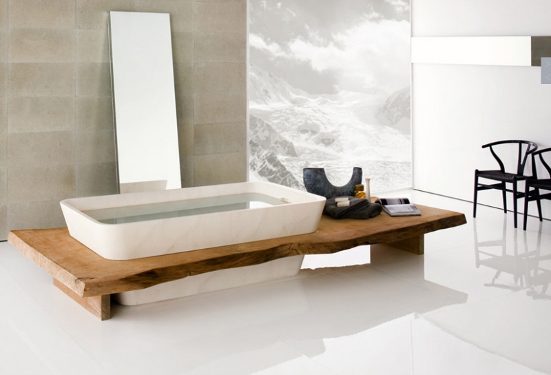a minimalist bathroom with Japanese aesthetics, a wooden bench, a large mirror next to the tub and a statement artwork
