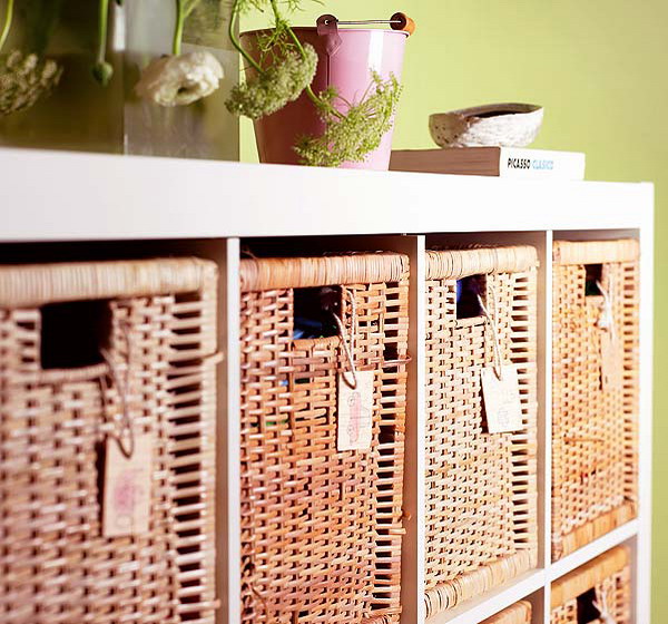 an open storage unit with wicker cubbies that make the storage closed, add a rustic feel and make it storage more comfortable