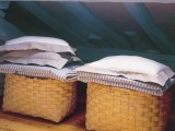 baskets with bedding and pillows can be used in your bedroom for storage