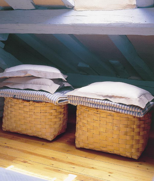 baskets with bedding and pillows can be used in your bedroom for storage