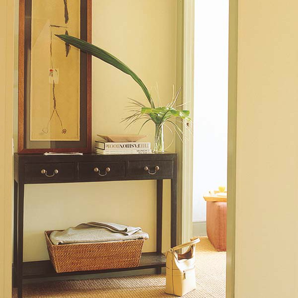 a black narrow entryway console table with a cubby to store various small stuff wherever you need
