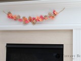 a bold paper leaf Thanksgiving garland hung over the fireplace is a stylish and bright decor idea to try