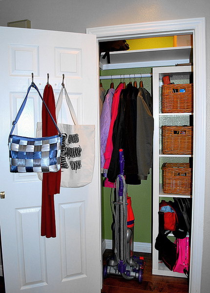 simple hooks on the door can hold all your bags and you won't have to sacrifice your shelf and floor space
