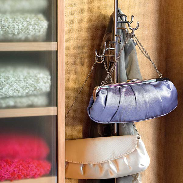 a regular clothes rack can hold a lot of bags   even if it's summer, don't take it away, let it be your holder