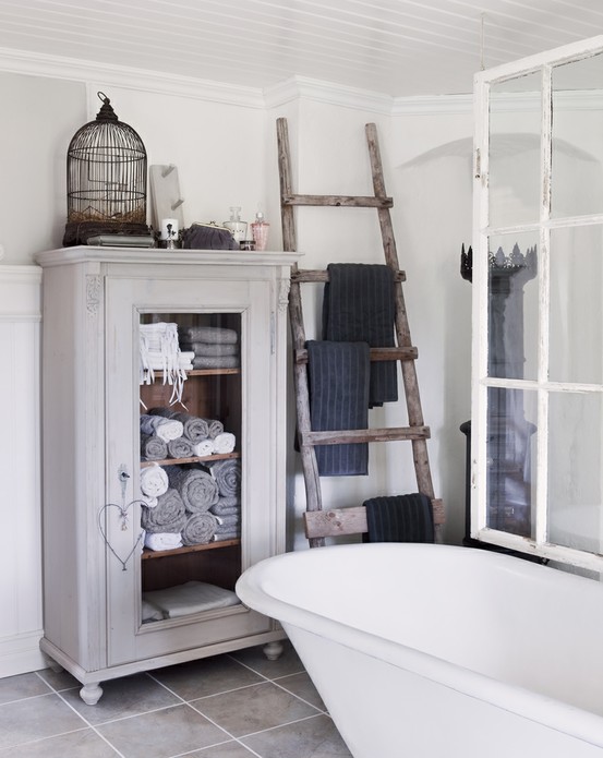 Wooden ladder and a vintage cabinet can solve all your bathroom storage organization needs