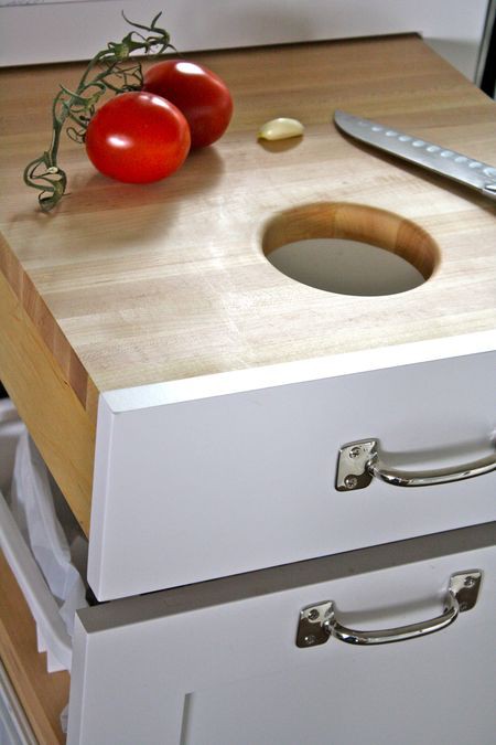 Here is a super smart pull out drawer with a pull out trash can and cutting area