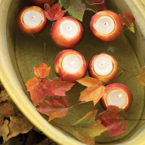 fall apples as candleholders cand be floating and you may add fall leaves to make the arrangement look cooler