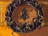 a black vine wreath with lots of snakes is a timeless front door decoration for Halloween