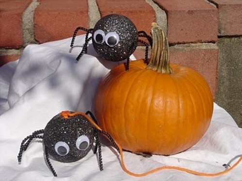a pumpkin with black glitter spiders is a lovely decoration for Halloween, make it for your kids' parties