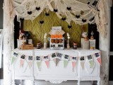 cheesecloth with bats and spiders hanging over the dessert table will make it look scary and Halloween-like