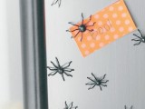 decorate your fridge with mini spiders to make it look scary and Halloween-like