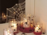 lots of candleholders of glass and mini spiders are nice for Halloween decor and a spiderweb on the window