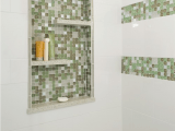 a green and white shower space with a niche with shelves used for storage only is a smart solution if there’s no space for shelves