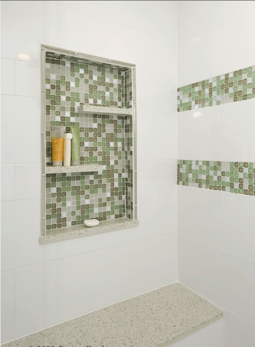 A green and white shower space with a niche with shelves used for storage only is a smart solution if there's no space for shelves