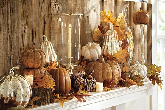 a vintage inspired Thanksgiving mantel with wooden, mercury glass and plastic pumpkins, fall leaves and candles