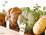 natural pumpkins with tags, pinecones and greenery for stylish rustic Thanksgiving decor