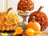 bright pumpkins and gourds, pumpkins covered with rust and orange blooms is a stylish Thanksgiving centerpiece