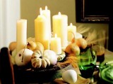a harvest centerpiece of a wooden bowl with pumpkins, pears, wheat and candles is easy to compose and very rustic