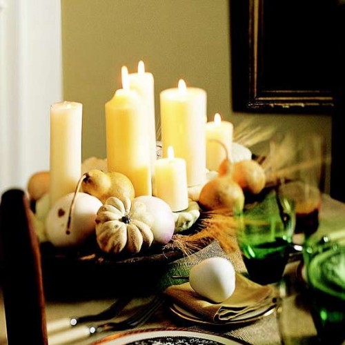 a harvest centerpiece of a wooden bowl with pumpkins, pears, wheat and candles is easy to compose and very rustic