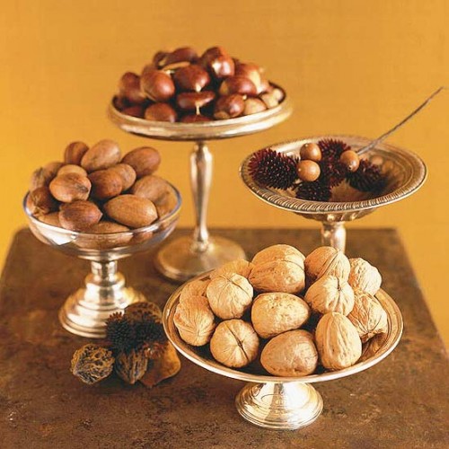 nuts, acorns and blooms in silver bowls on high stands is an elegant and chic fall centerpiece