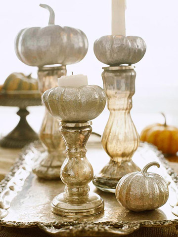 grey pumpkins with candles placed on mercury glass stands are a lovely vintage centerpiece for the fall