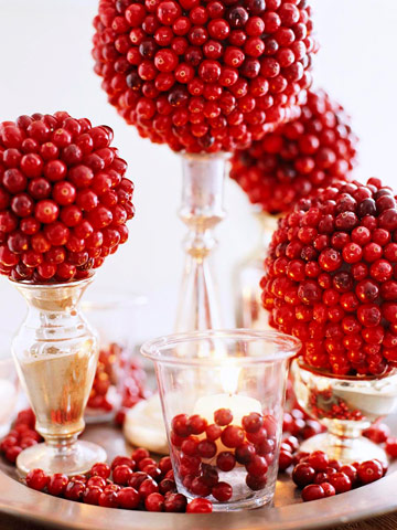 cranberry topiaries and candles can be used not only for a Christmas party but also for Thanksgiving