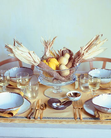 a glass bowl with corn cobs, pears and pumpkins is ideal for fall or Thanksgiving