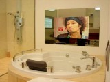 hang a TV mirror over the bathtub to enjoy watching your favorite shows while having a relaxing bath