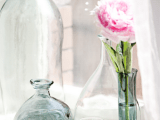 neutral and blue glass vases with flowers and just bottles placed on a windowsill add chic and interest to the space
