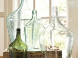 an arrangement of vintage bottles of various sizes and shapes is a chic and cool decoration to add a vintage feel to the space