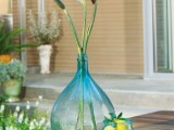 beautiful blue bottles with blooms and with lemons for decorating your spaces, indoor and outdoor ones