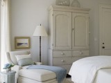a neutral vintage bedroom with large bottles on the wardrobe that make it catchy and interesting